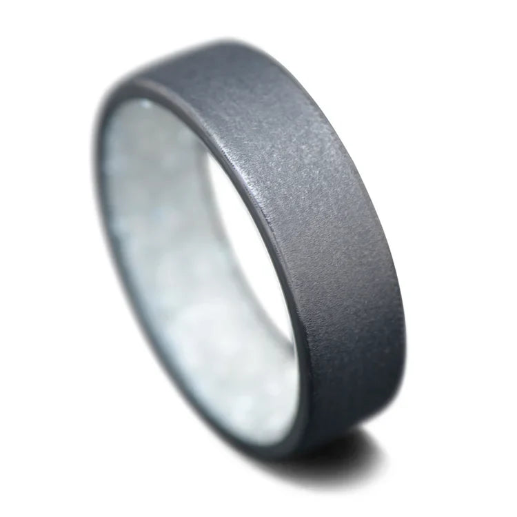 Black titanium wedding band with granite finish and pearl inner sleeve, 7mm mens wedding ring, custom mens ring on white background, free engraving available