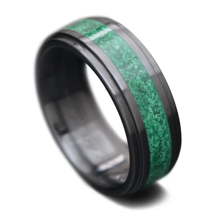 Black titanium wedding band with central malachite inlay, 7mm wide, mens unique ring, free engraving option, displayed on a white background.