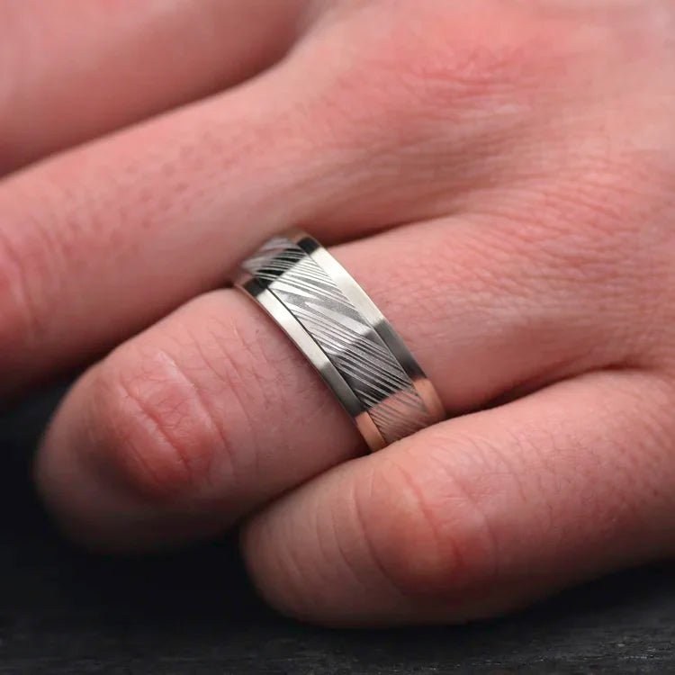 Mens 14KW wedding band with central Heimskringla inlay and whiskey barrel oak inner sleeve, 9mm polished finish, worn on a hand, free engraving available.
