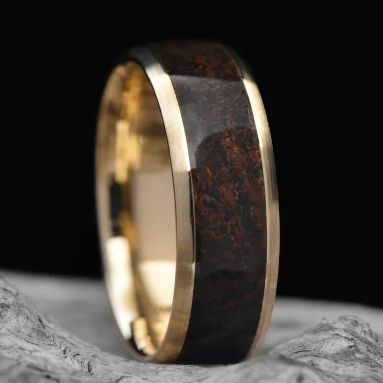 10KY gold mens wedding band with solid T-Rex central inlay, 7mm unique custom design, free engraving, displayed on a white sea branch.