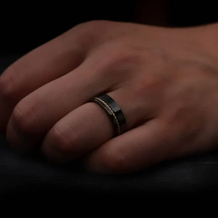 Mens hand wearing a Black Titanium Wedding Band with 10KY Rope and Whiskey Barrel Oak Inlay, 7mm unique mens wedding ring with free engraving.