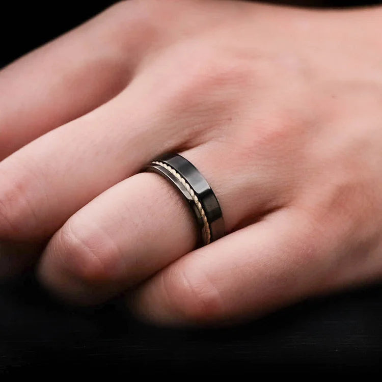 Mens hand wearing a Black Titanium Wedding Band with 10KY Rope and Whiskey Barrel Oak Inlay, 7mm unique mens wedding ring with free engraving.