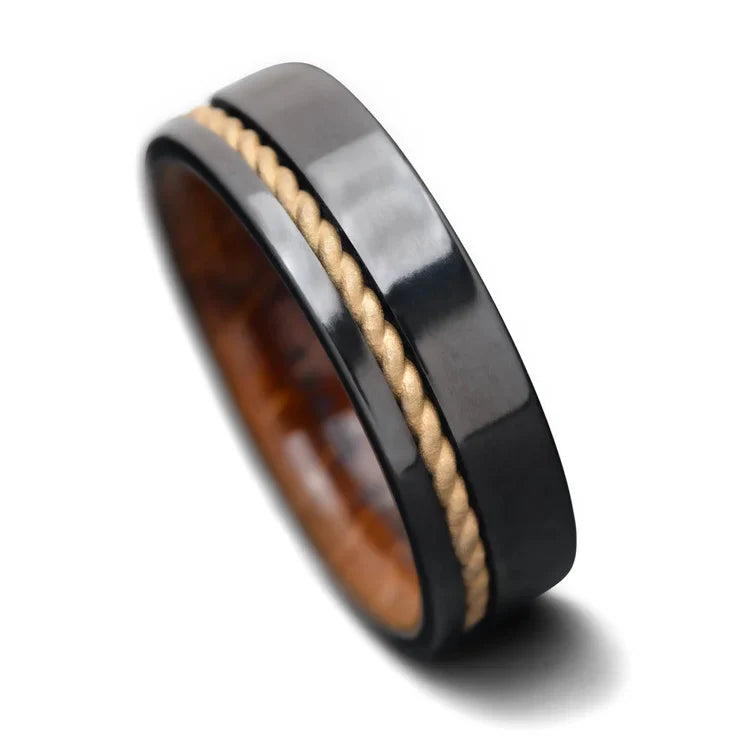 Black titanium wedding band featuring 10KY gold rope and whiskey barrel oak inlay, 7mm mens ring, unique design, free engraving option, displayed on a white background.