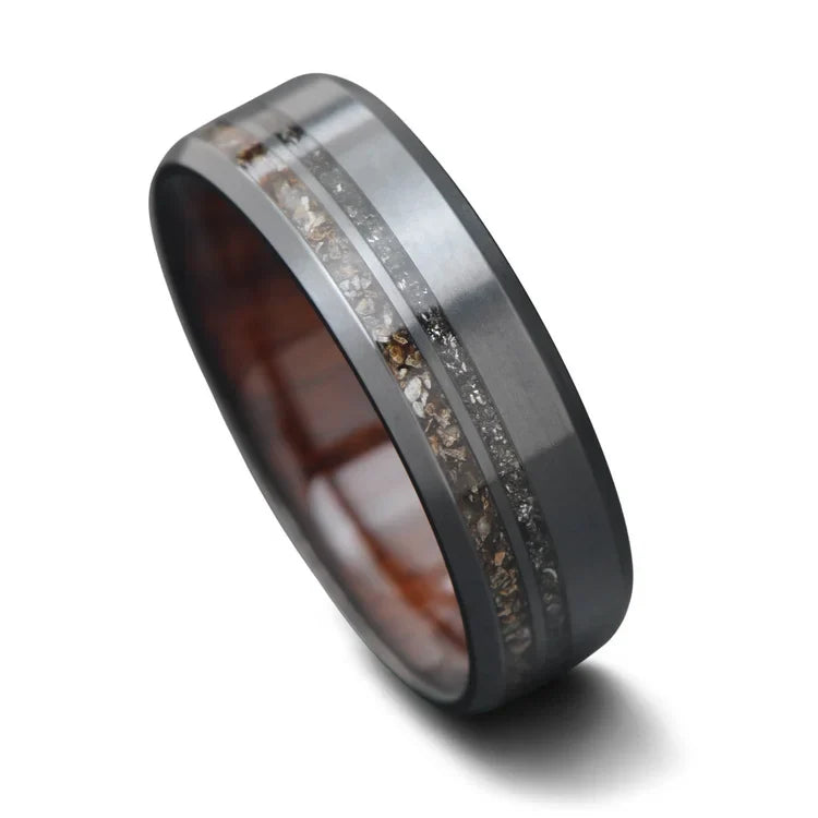 Black titanium wedding band featuring crushed T-Rex bone and meteorite inlays, 7mm width, mens ring with a unique WW2 rifle inner sleeve, free engraving available, displayed on a white background.
