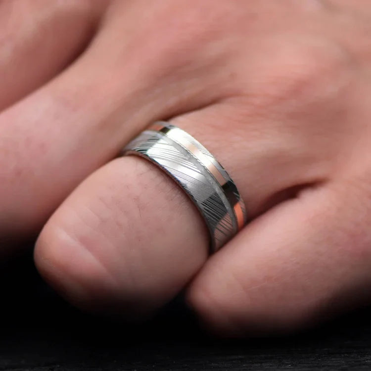 Heimskringla Wedding Band with 14K Rose Gold and Pearl Inlays on a hand, featuring an 8mm mens ring with olivewood inner sleeve and polished flat profile, offering free engraving.