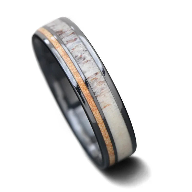 Black titanium wedding band featuring deer antler and birds eye maple inlays, 6mm mens ring with polished flat profile, available with free engraving, displayed on a white background.