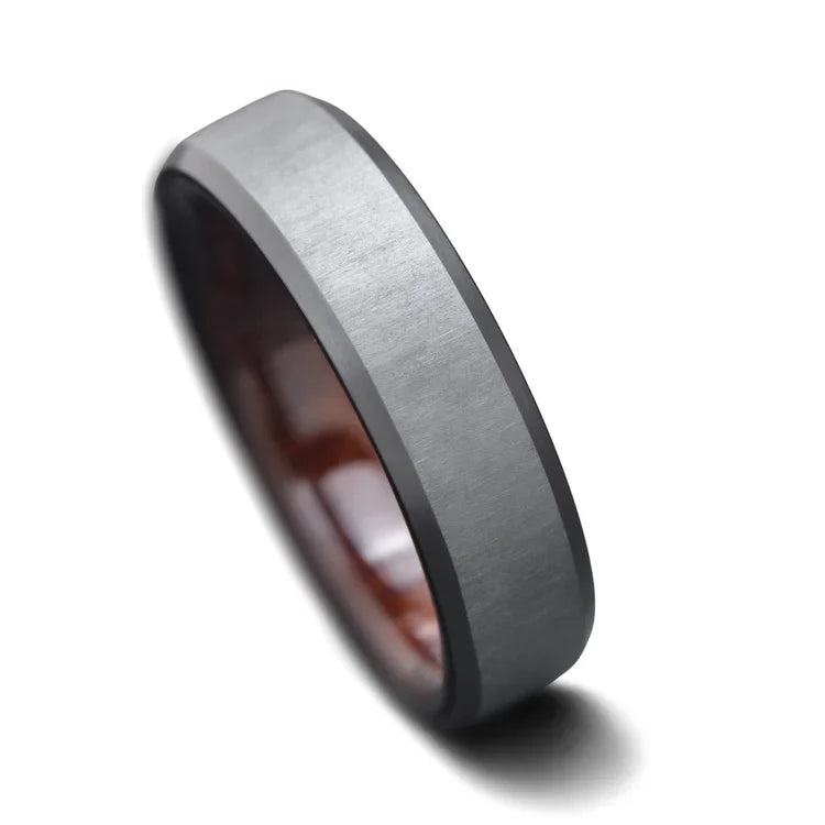 Black titanium wedding band with koa wood inner sleeve, 6mm mens ring, brushed bevel profile, free engraving, on a white background.