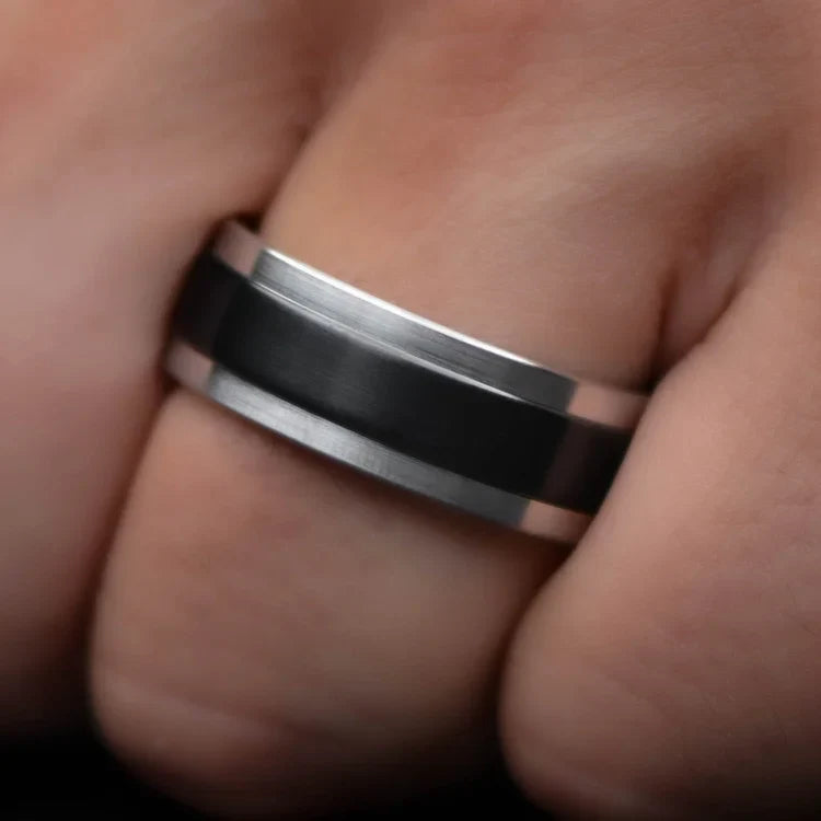 Mens 9mm aluminum wedding band with central zirconium inlay, polished step profile, unique design, free engraving, shown on hand.