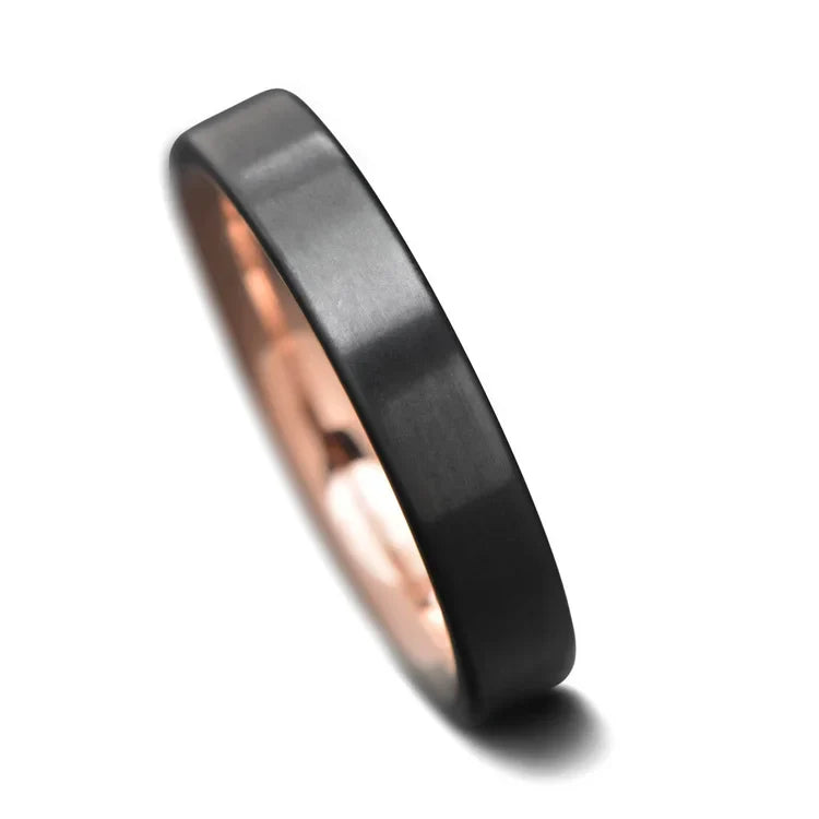 Black titanium wedding band with 14K rose gold inner sleeve, 4mm width, custom simple design, unique wedding ring on a white background, free engraving available.