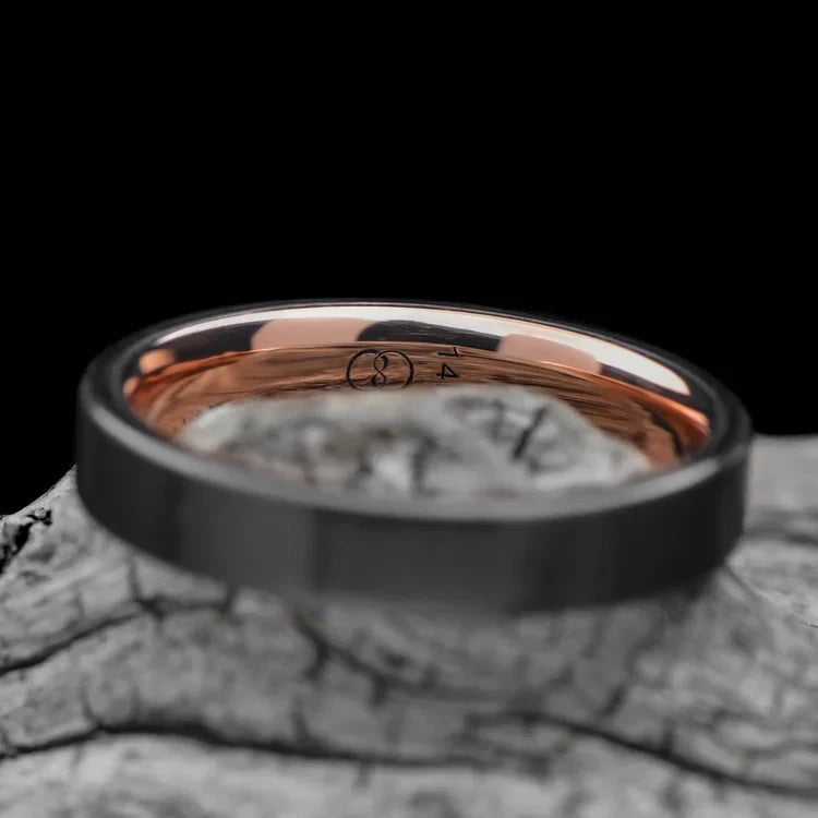Black titanium wedding band with 14K rose gold inner sleeve on white sea branch, 4mm custom simple unique wedding ring with free engraving.
