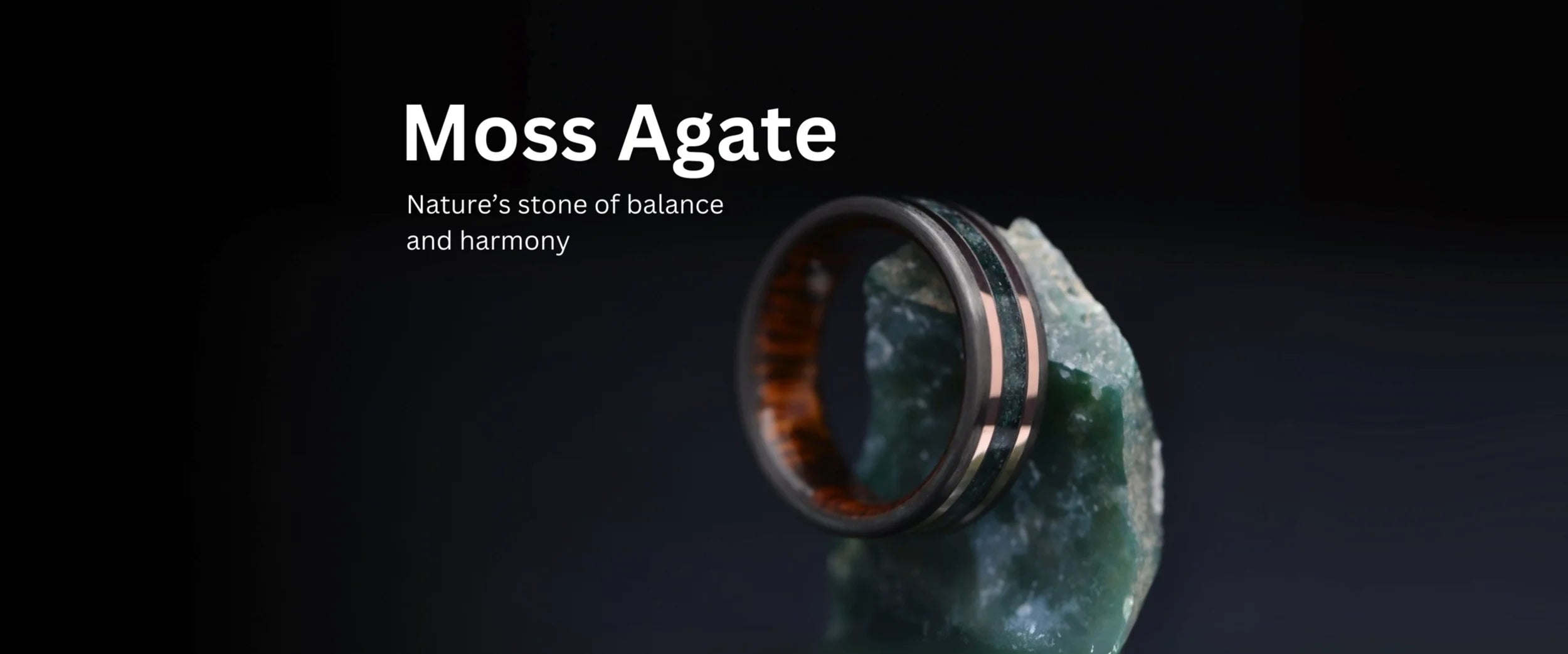 Moss Agate wedding band with rose gold inlay handcrafted by Sesto Synergy, displayed on natural moss agate stone