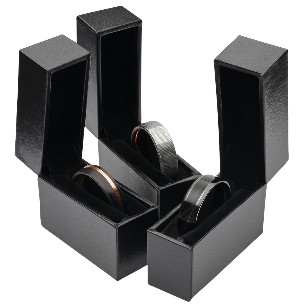 Three open black Sesto Synergy ring boxes, each holding a ring