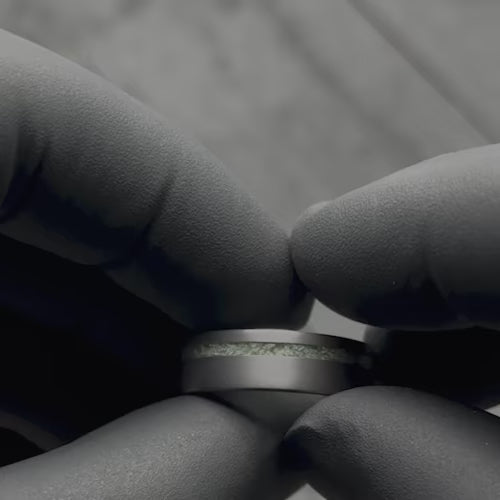 Video of a mens 7mm tantalum wedding band with jade inlay, featuring a brushed flat profile, being showcased with black gloves; includes free engraving and highlights the unique design of this mens ring.